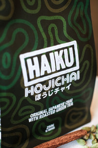 Packaging of Haiku Houichai green tea with green and white design.
